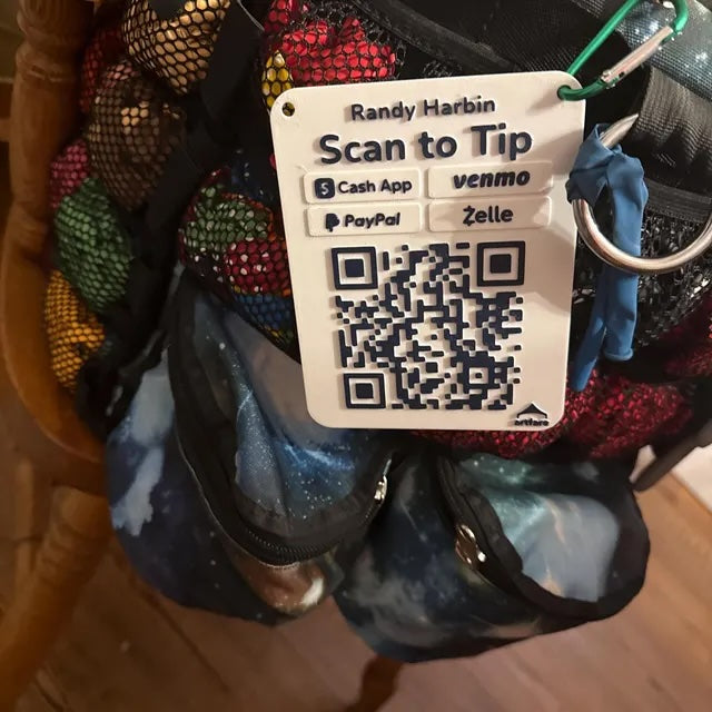 Artfare QR payment sign in use with balloon animal performer