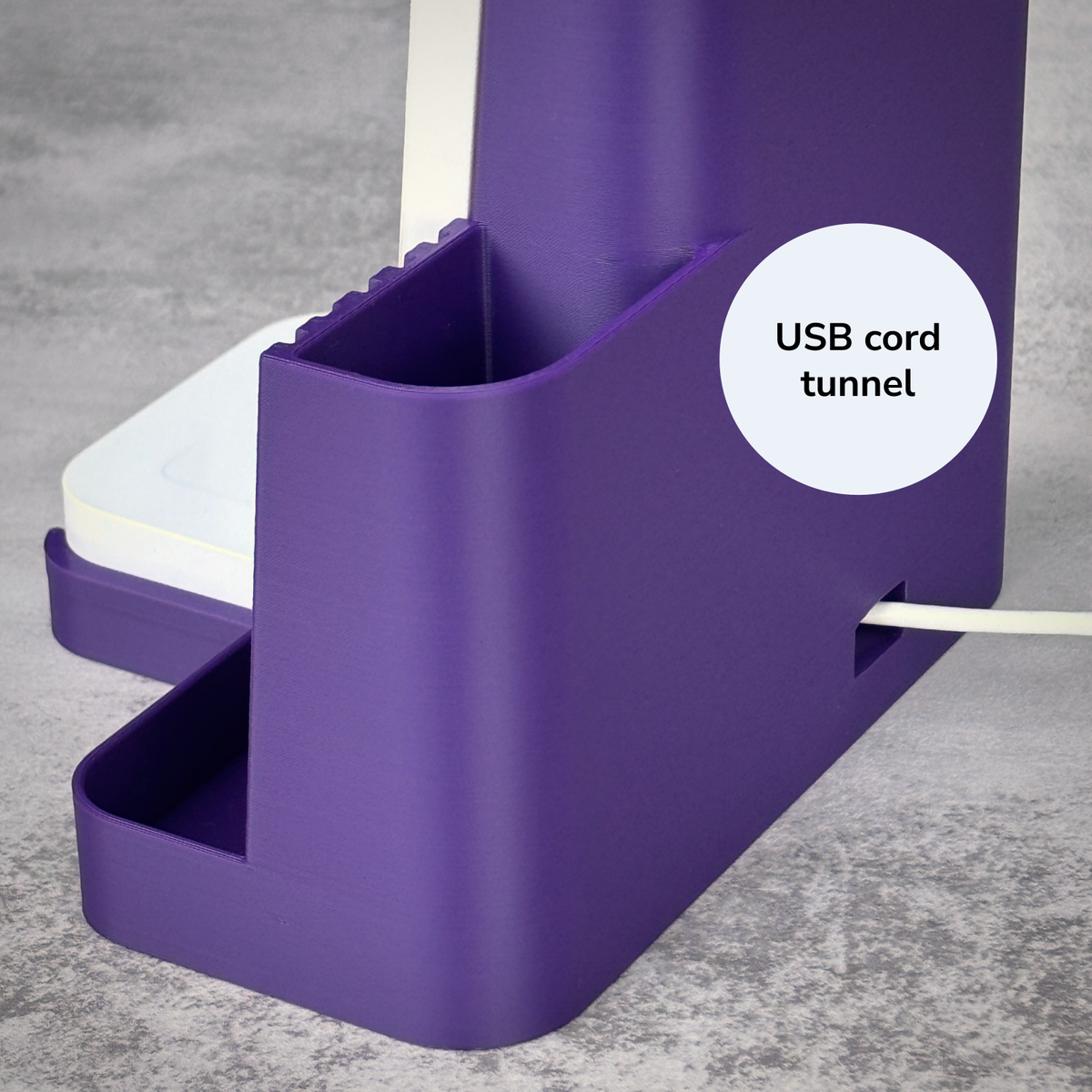 Back of the purple Shopkeeper dock showing the USB cord tunnel that keeps the Square Reader powered